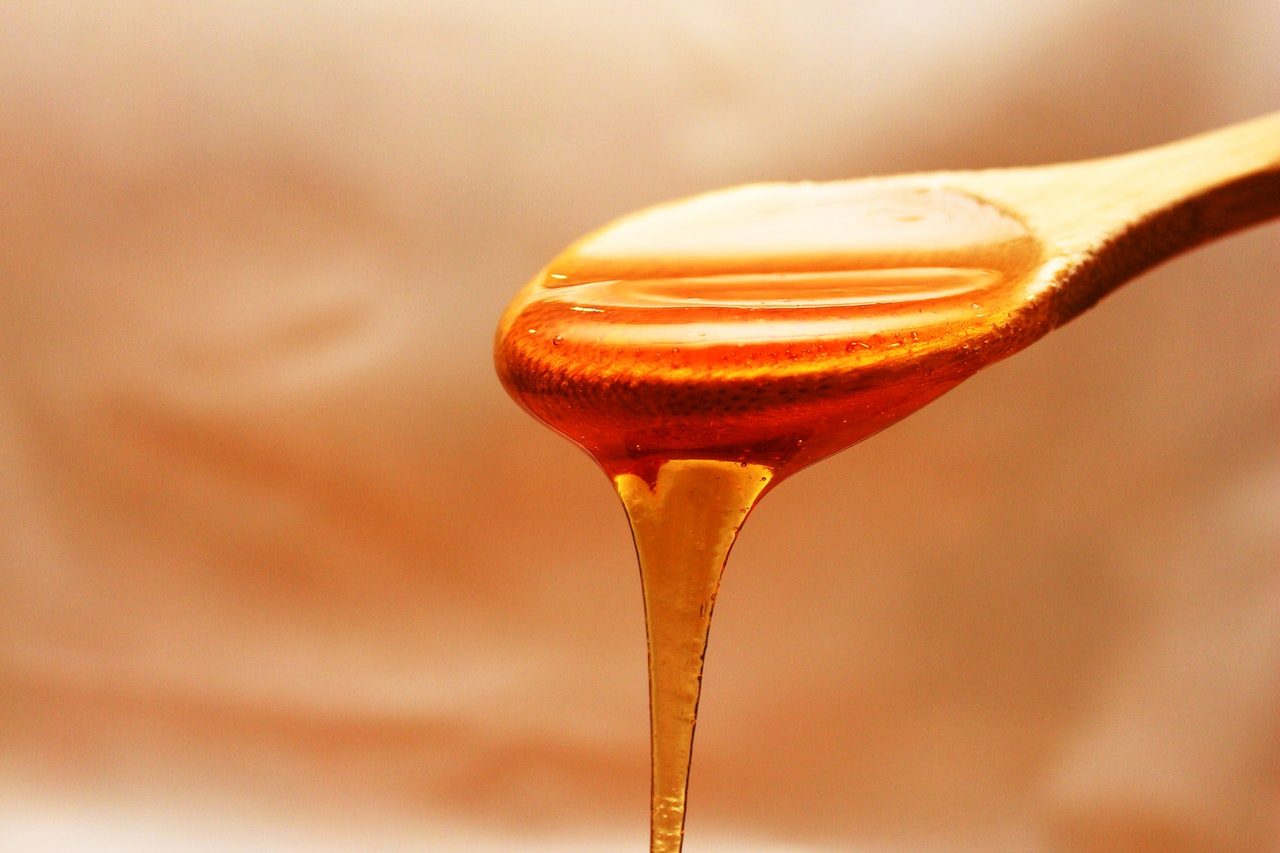 Honey pouring from spoon